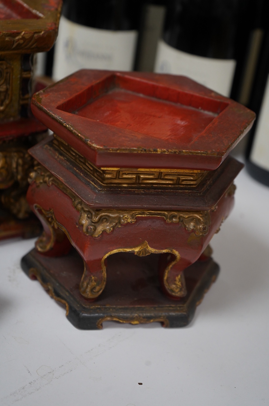 Five Chinese lacquered and partially gilt stands including a hexagonal pair, largest 15cm high. Condition - mostly fair